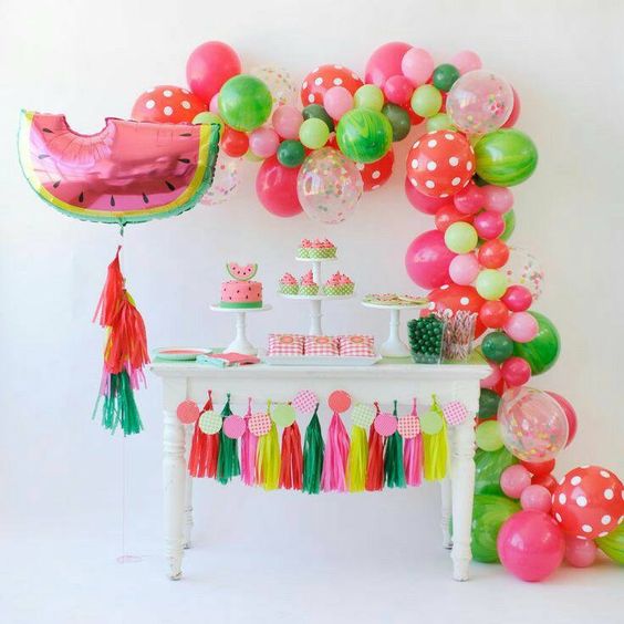 Dessert tables with flamingos pineapple and fruit balloons