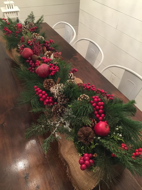 Christmas centerpiece with wooden box, pineapples and branches