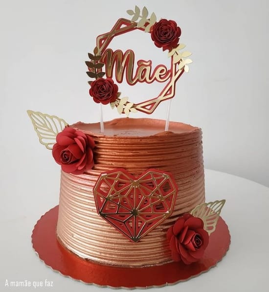 red and gold cake with top with roses