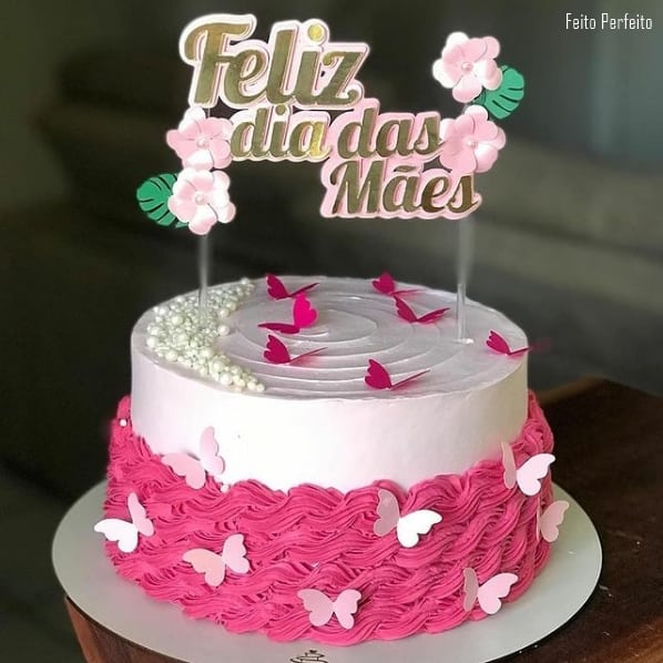 pink cake with mothers day top with flowers