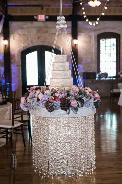 Beautiful multi-storey cake on a stand with sparkles and flowers