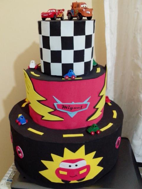 Fully customized three-tier cake with various colored molds