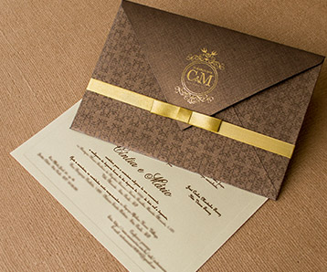 Rustic wedding invitation envelope with golden bow