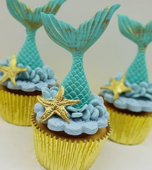 Cupcake with mermaid syrup and starfish decoration.