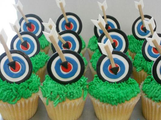 Cupcakes decorated with target and arrow ornament.