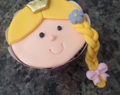 Rapunzel cupcake with braid.
