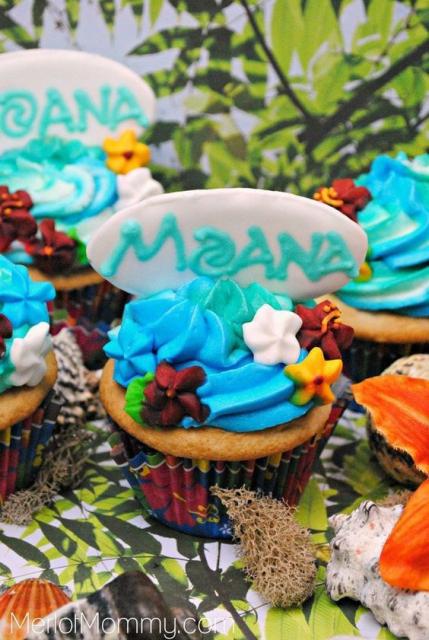Cupcakes decorated with blue icing and flowers.