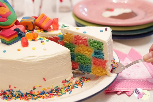 Colorful checkered cake with white icing