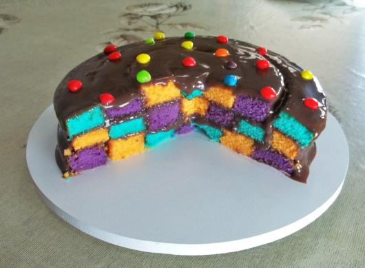 Colorful checkered cake with icing and confetti