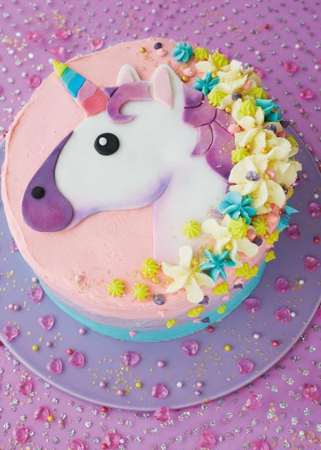 Colorful unicorn cake with whipped cream
