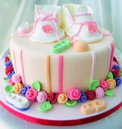 Colorful baby shower cake with slipper on top