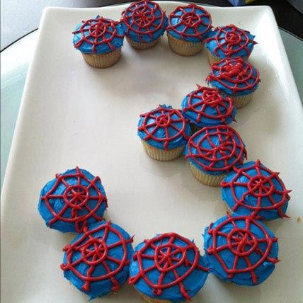 Cupcakes with blue dough and red web for a children's birthday party
