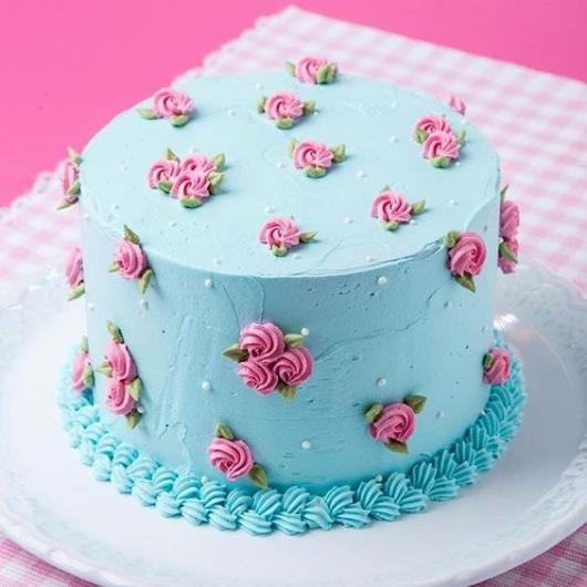 Delicate blue and pink cake with small roses
