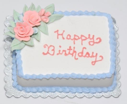Cake decoration with blue whipped cream and written in pink