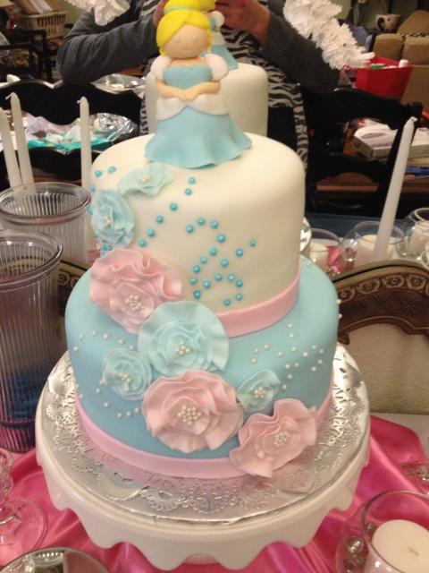blue and light pink cinderella cake with a white base of American paste