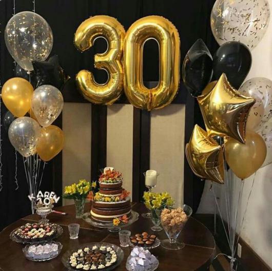Golden number balloons in silver and gold black decoration