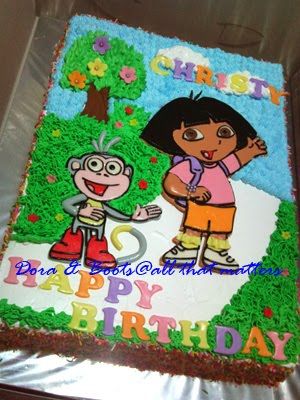 Adventurous Dora cake topped with whipped cream.