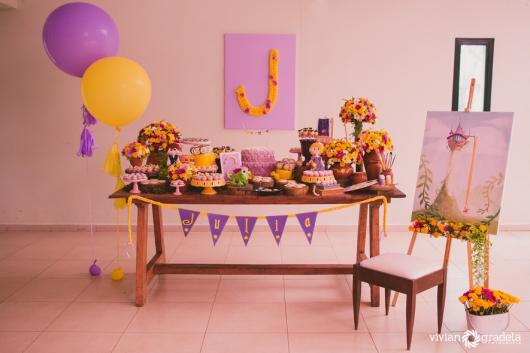 Simple Rapunzel party decorated with rustic table and paper panel