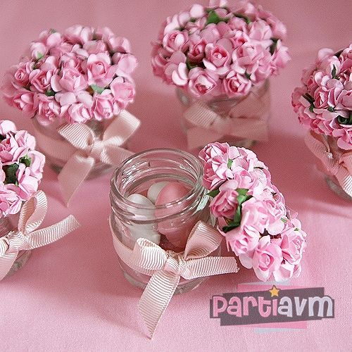 Glass jars for souvenirs decorated with flowers and bow.