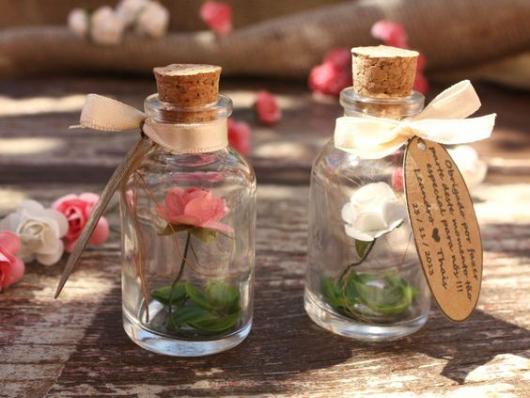 Glass jars for souvenirs with flower inside.