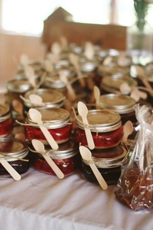 Glass jars for souvenirs with candy inside and spoon.