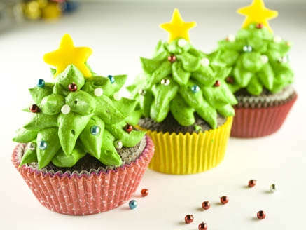 Christmas cupcake decorated with whipped cream tree and star confetti
