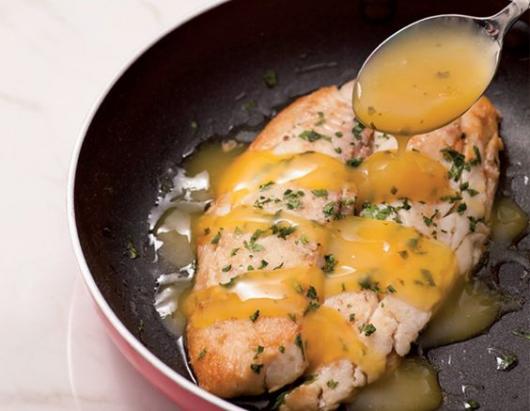 Fish in a frying pan, with sauce.