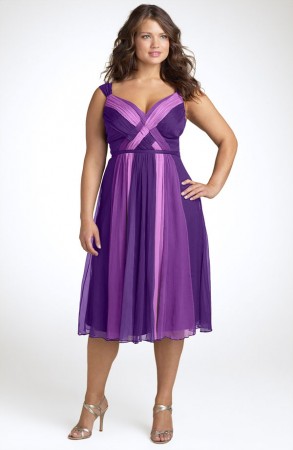 Model wears dark purple dress combined with silver sandals.
