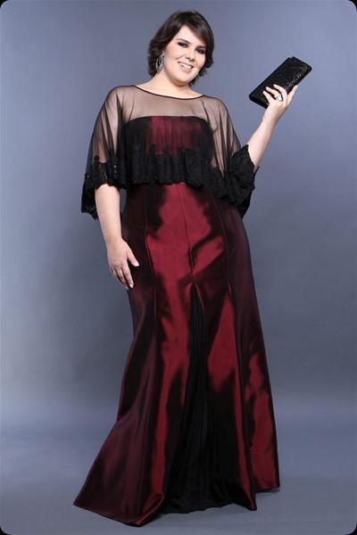 Model wears long burgundy satin dress.