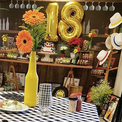 Themes for an 18th birthday party bar with a bottle-shaped centerpiece