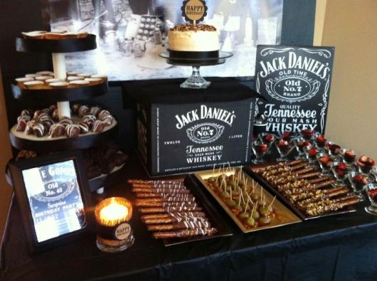 Cake table with candy skewers and Jack Daniel's whiskey drawings