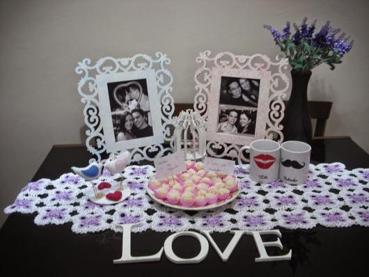 table with photos of the couple and kisses