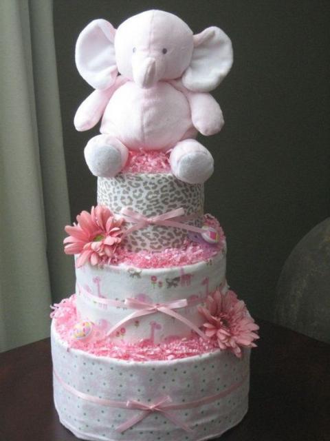 fake feminine cake with pink flowers, pink bows and a pink elephant on top
