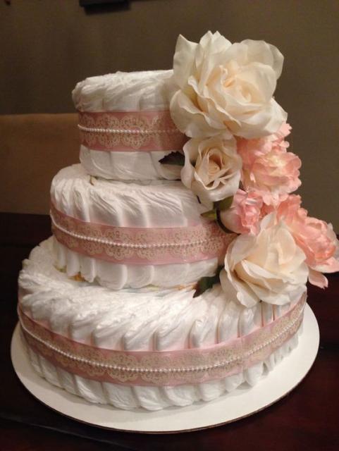 fake feminine cake with pink ribbon details and pink flowers
