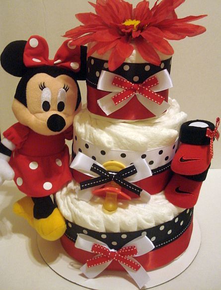 Minnie themed female fake cake, with a plush Minnie, red shoes, flower, bows and polka dot prints
