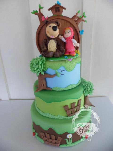 Four-tier green fake cake with the Bear and Masha on top.