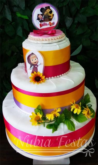 White cake with pink, orange and lilac ribbons.