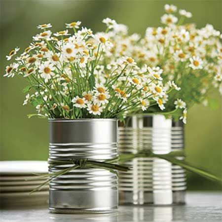Cans serving as white flower pots.