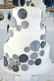 White layer cake with gray baubles.