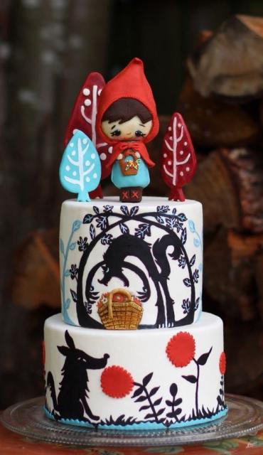 Two-story red hat cake with white base and black drawings of the forest and the Wolf 