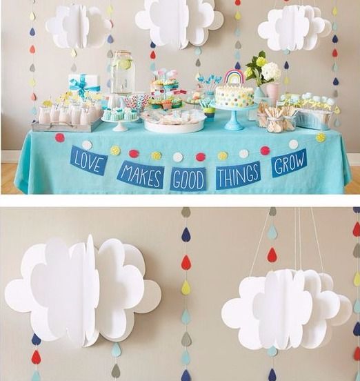 Paper clouds on cake table background with blue decoration.