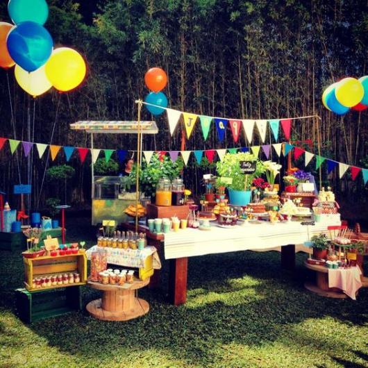 Garden party, decorated with colorful balloons and flags.