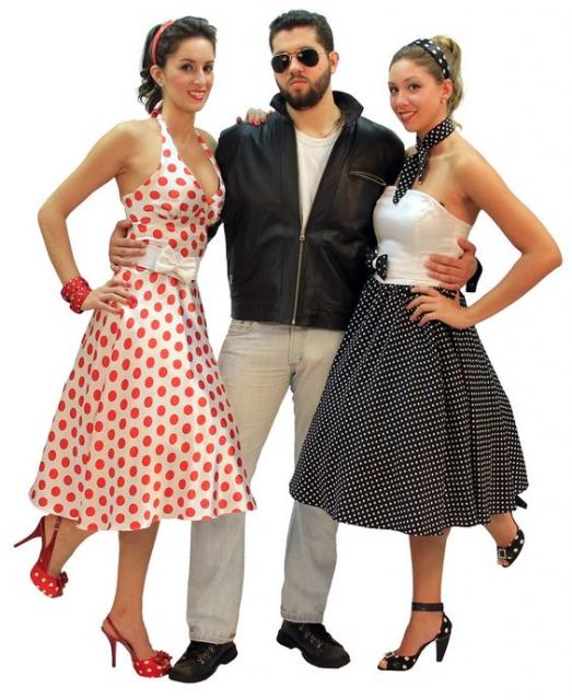 Two women and a man in 60s clothes.