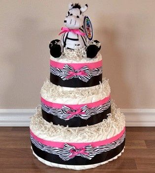 female fake cake with zebra print and a plush zebra on top